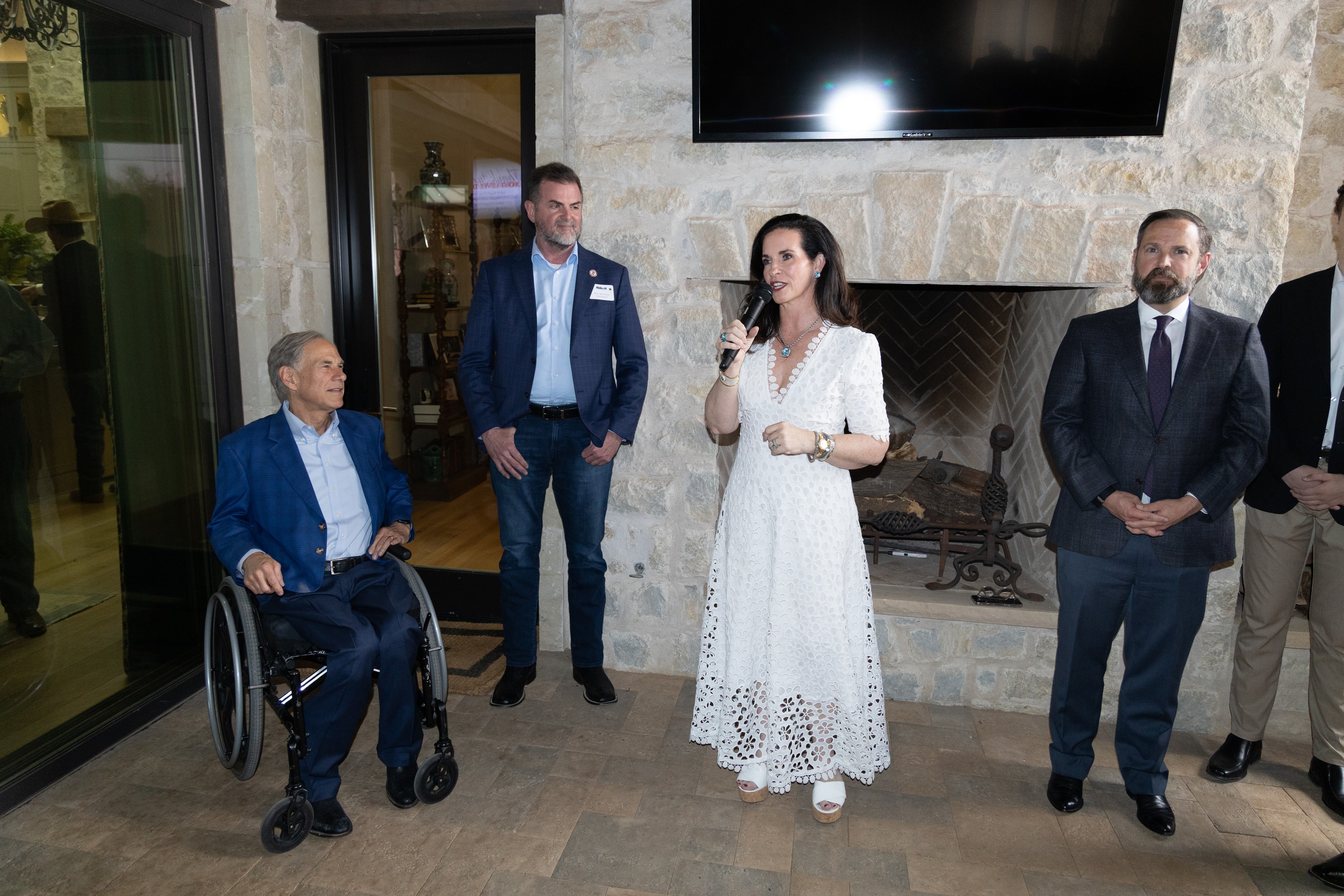 Ashley speaking at a formal indoor event